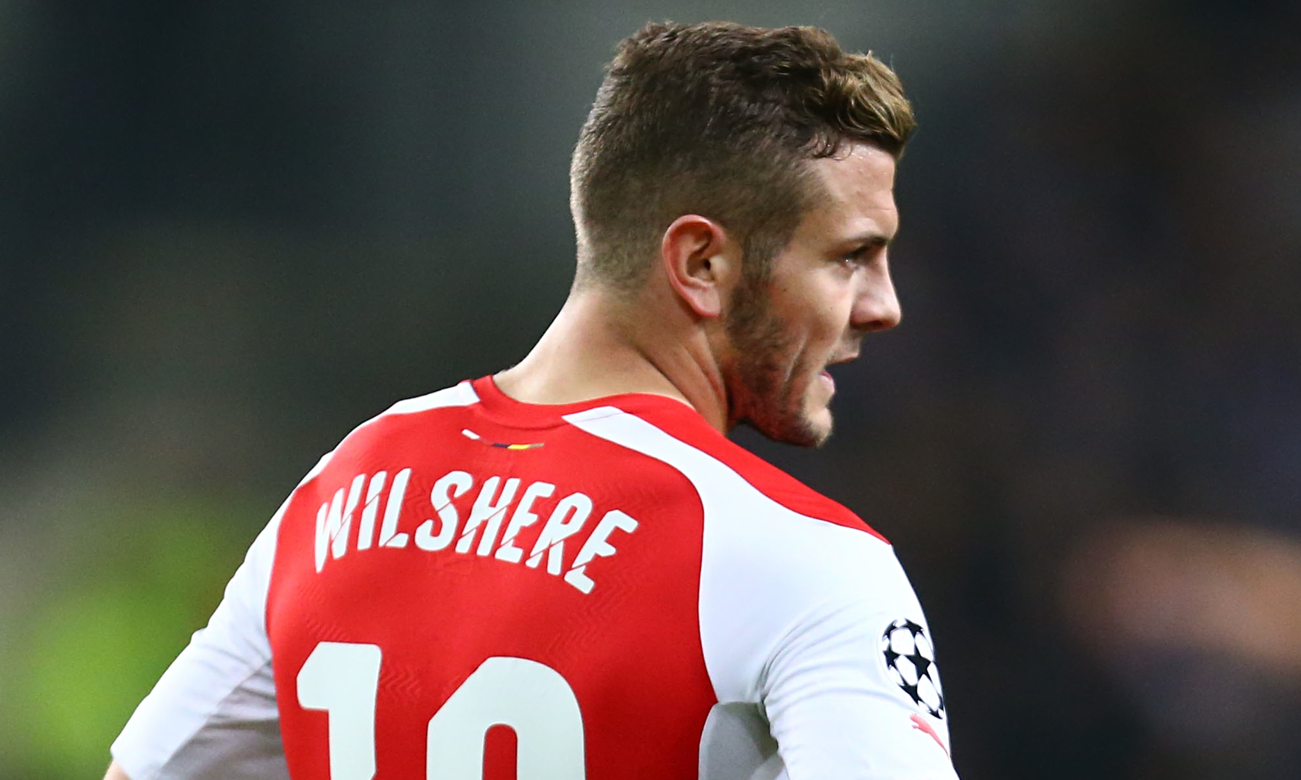 Jack Wilshere standing with his hands on his hips
